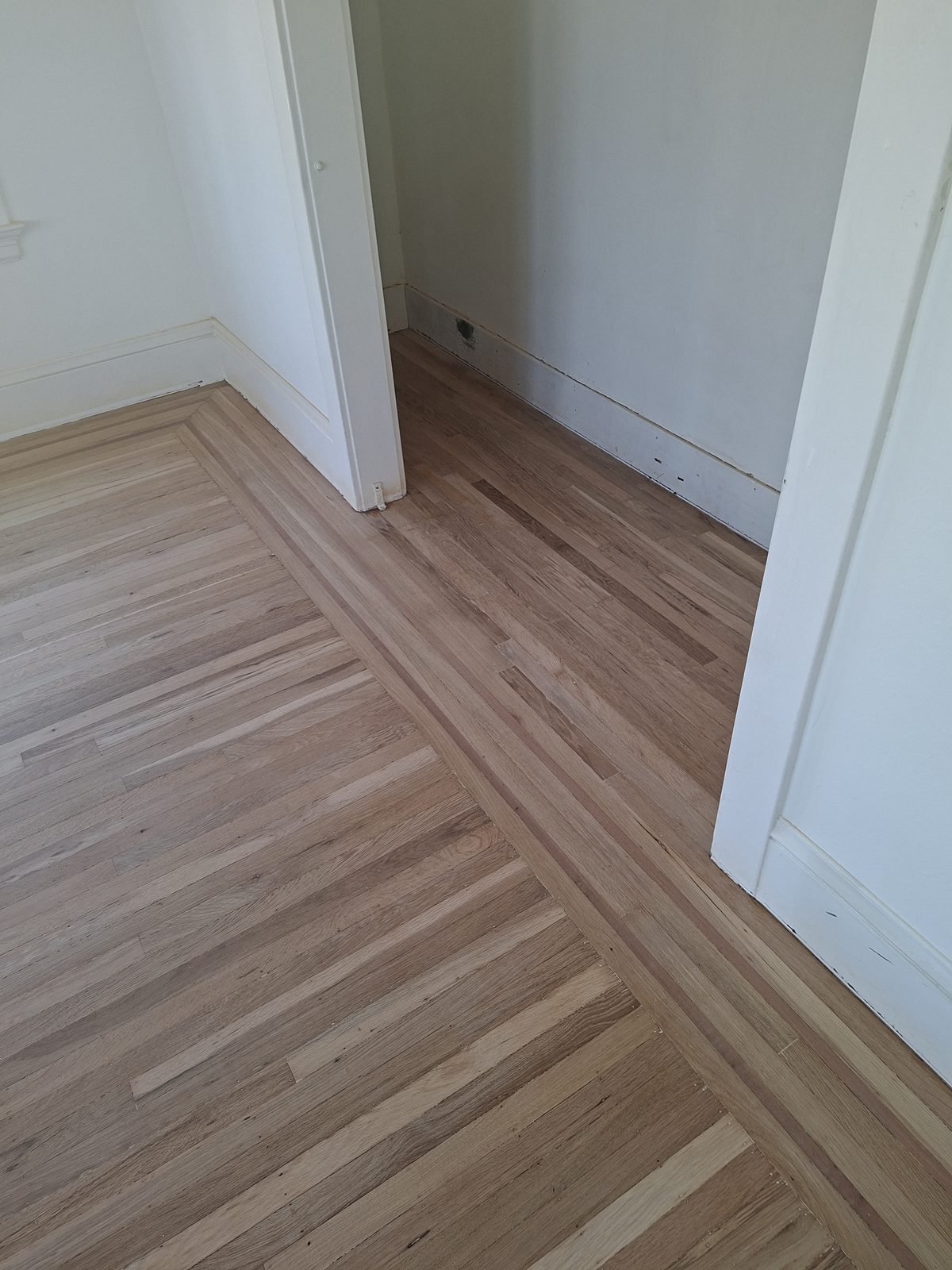 Newly installed light hardwood floors in a Glen Park home remodel