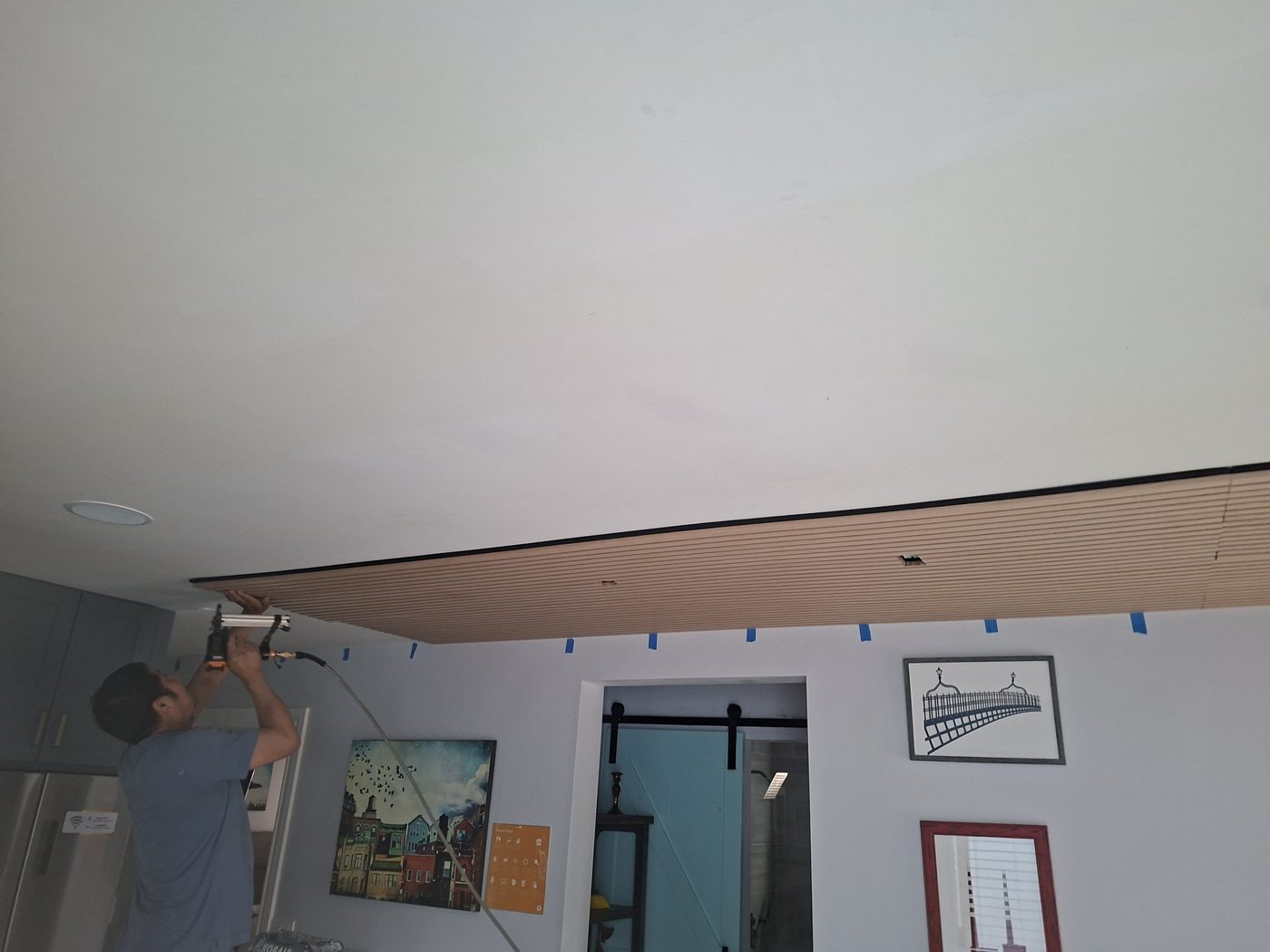 Behan Builders crew installing custom wood slat ceiling during a San Francisco home remodel