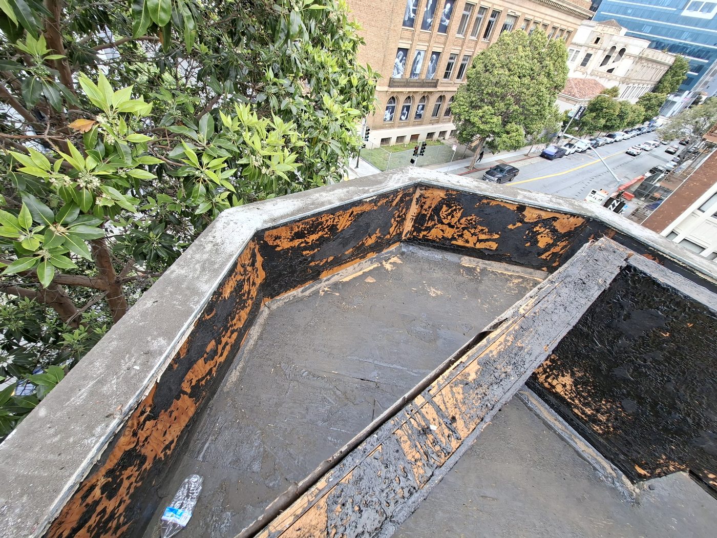Exposed flashing and waterproofing detail during exterior moisture remediation work