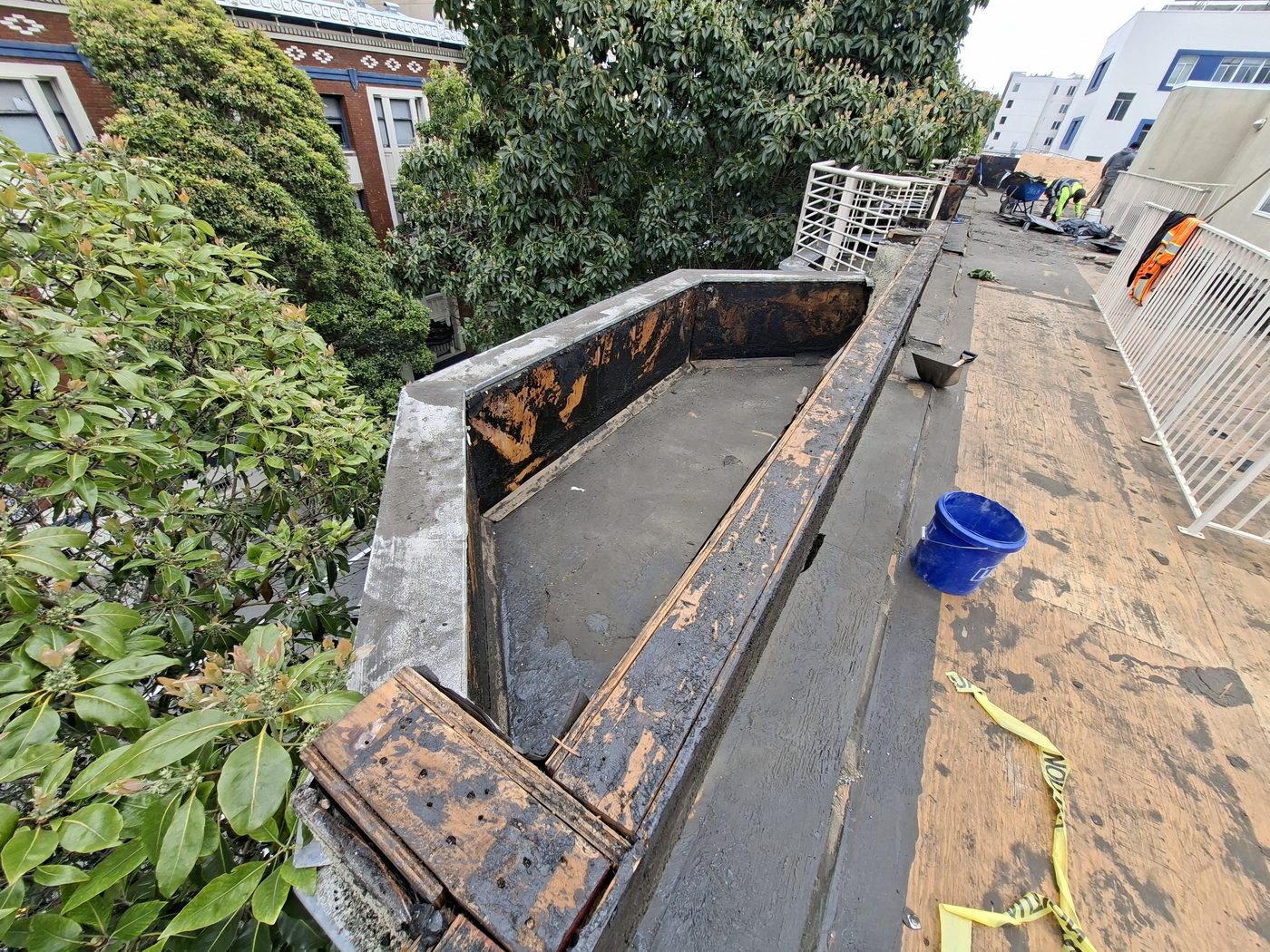 Roof edge with failed flashing and wood damage exposed during dry rot remediation