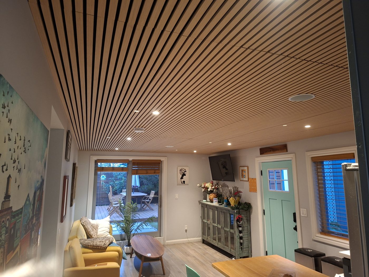 Completed full home remodel in San Francisco, open plan interior with custom wood slat ceiling and modern finishes
